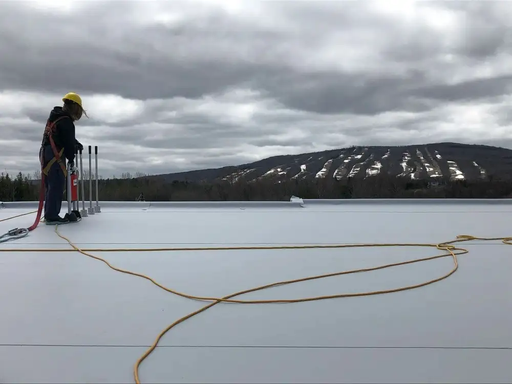 A person standing on the roof of a building
