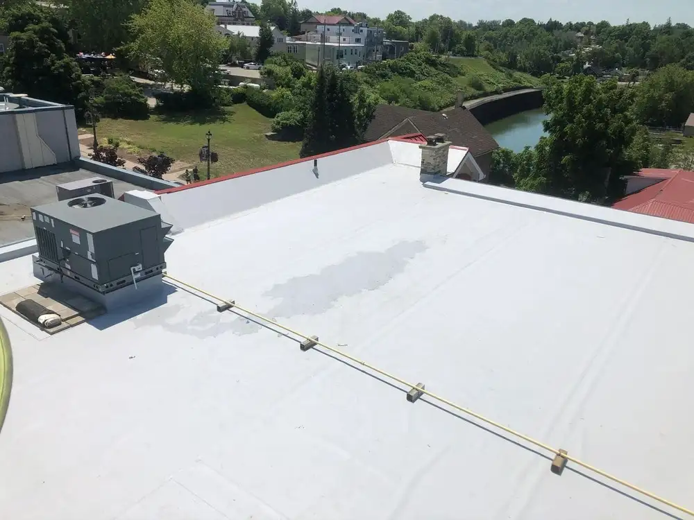 A white roof with water coming out of it.