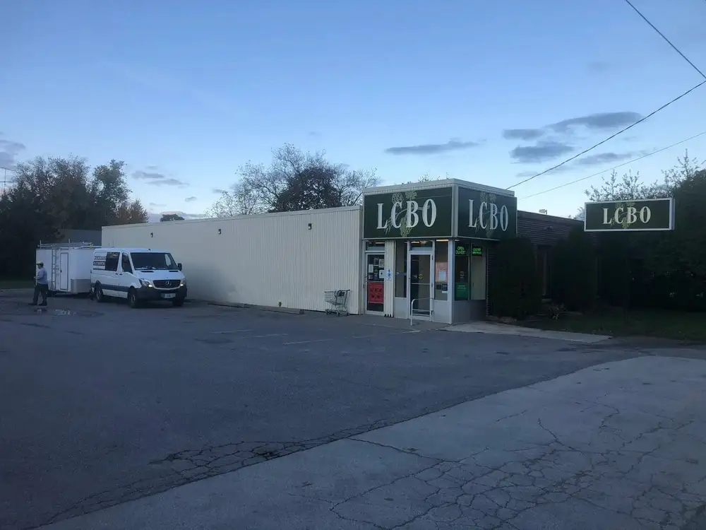 A van parked in front of a store.