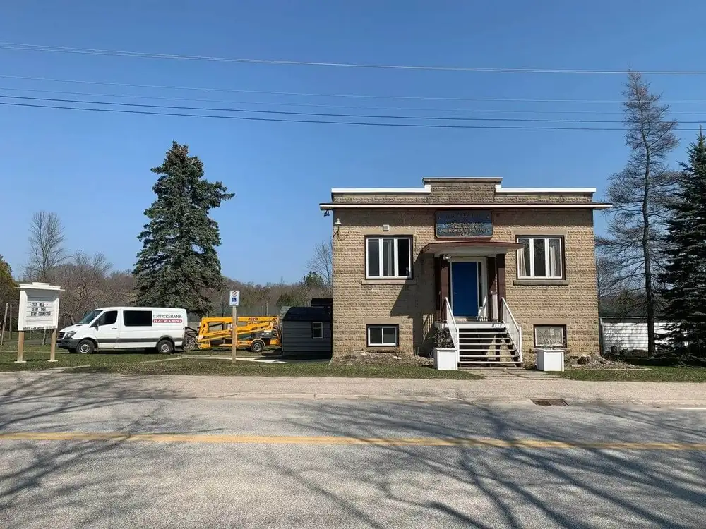 A van parked in front of a brick building.