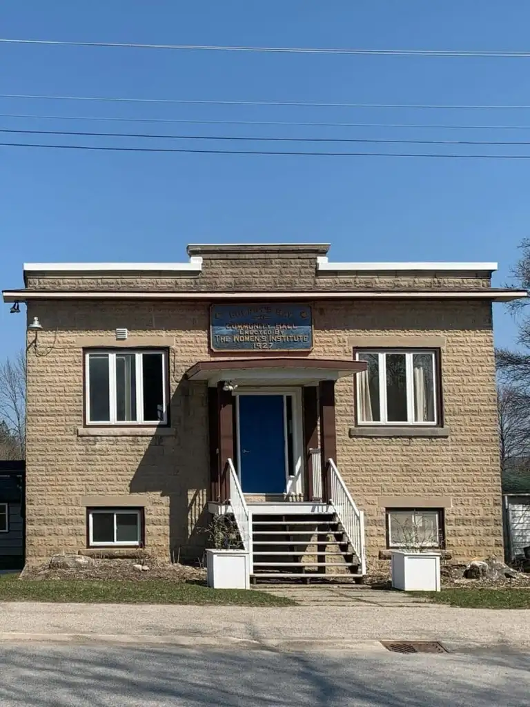 A brick building with steps leading to the front door.