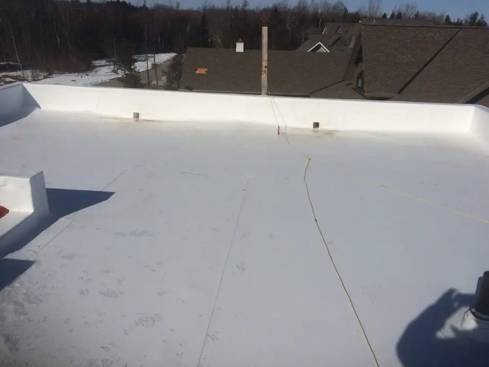 A person standing on top of a roof.